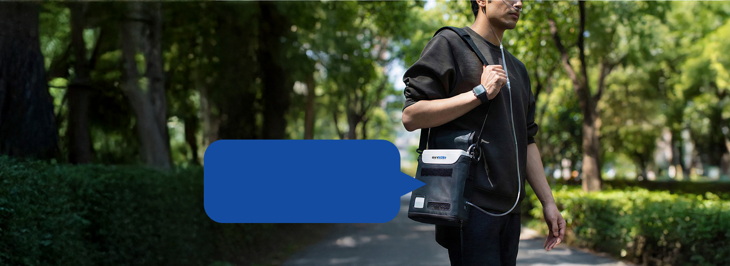 Person walking outdoors with Oxysure Go in its sling bag